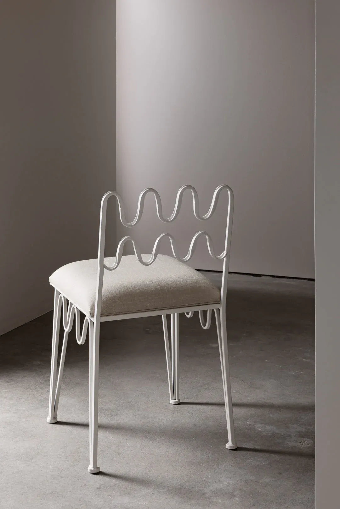 Unique dining chair with wave design, perfect for contemporary dining sets.