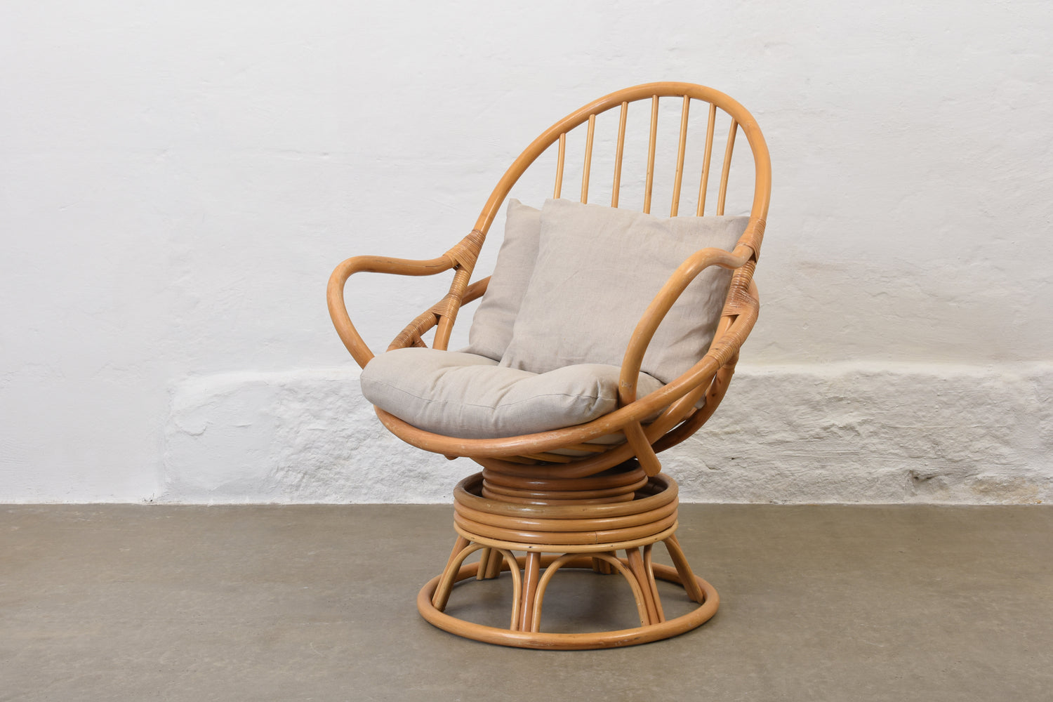 Caned Egg-Shaped Swivel Armchair: Timeless Coastal Comfort Reimagined