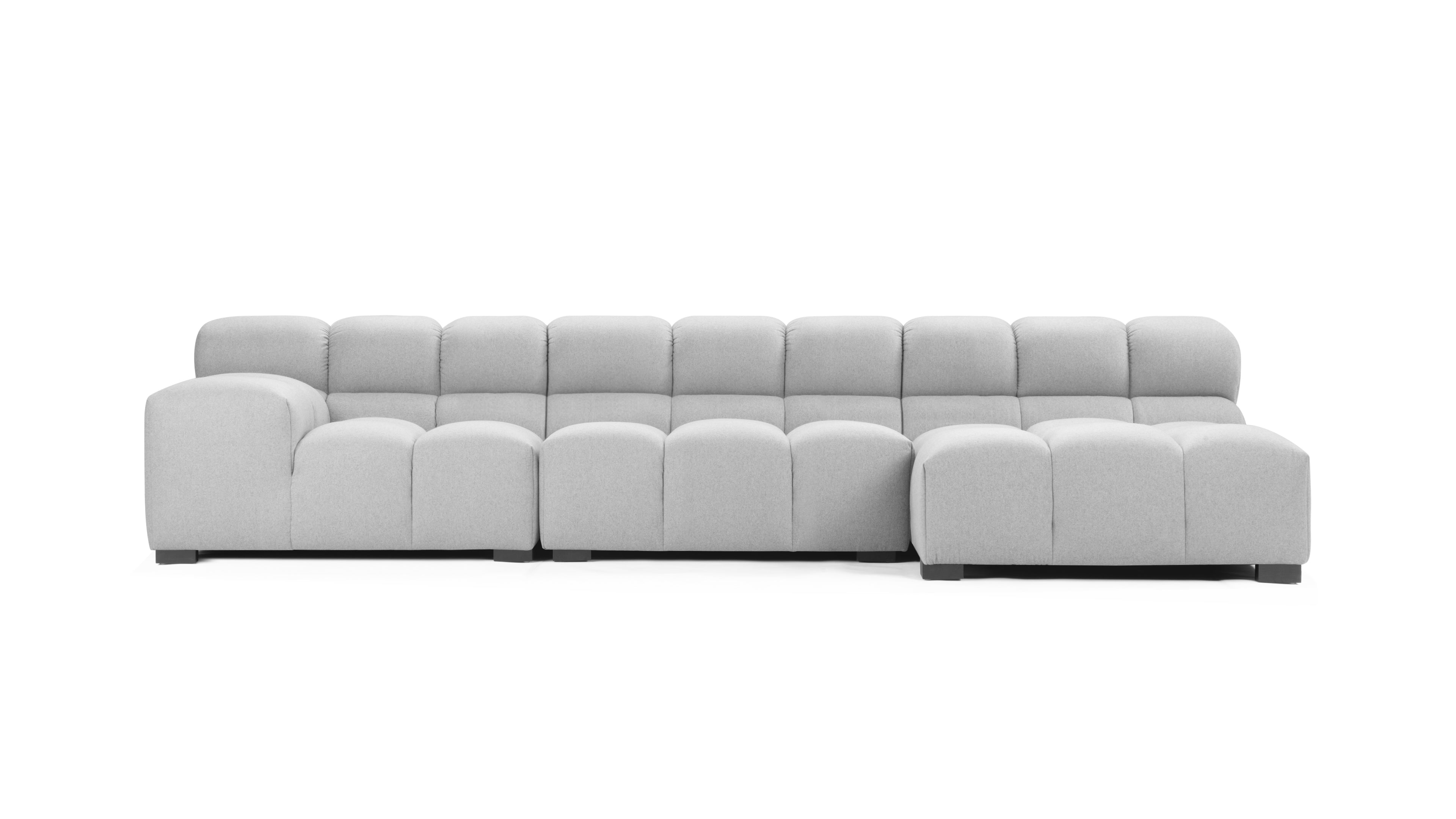 Elegantly designed light gray tufted couch with a right chaise, showcasing modern craftsmanship and mid-century aesthetics.