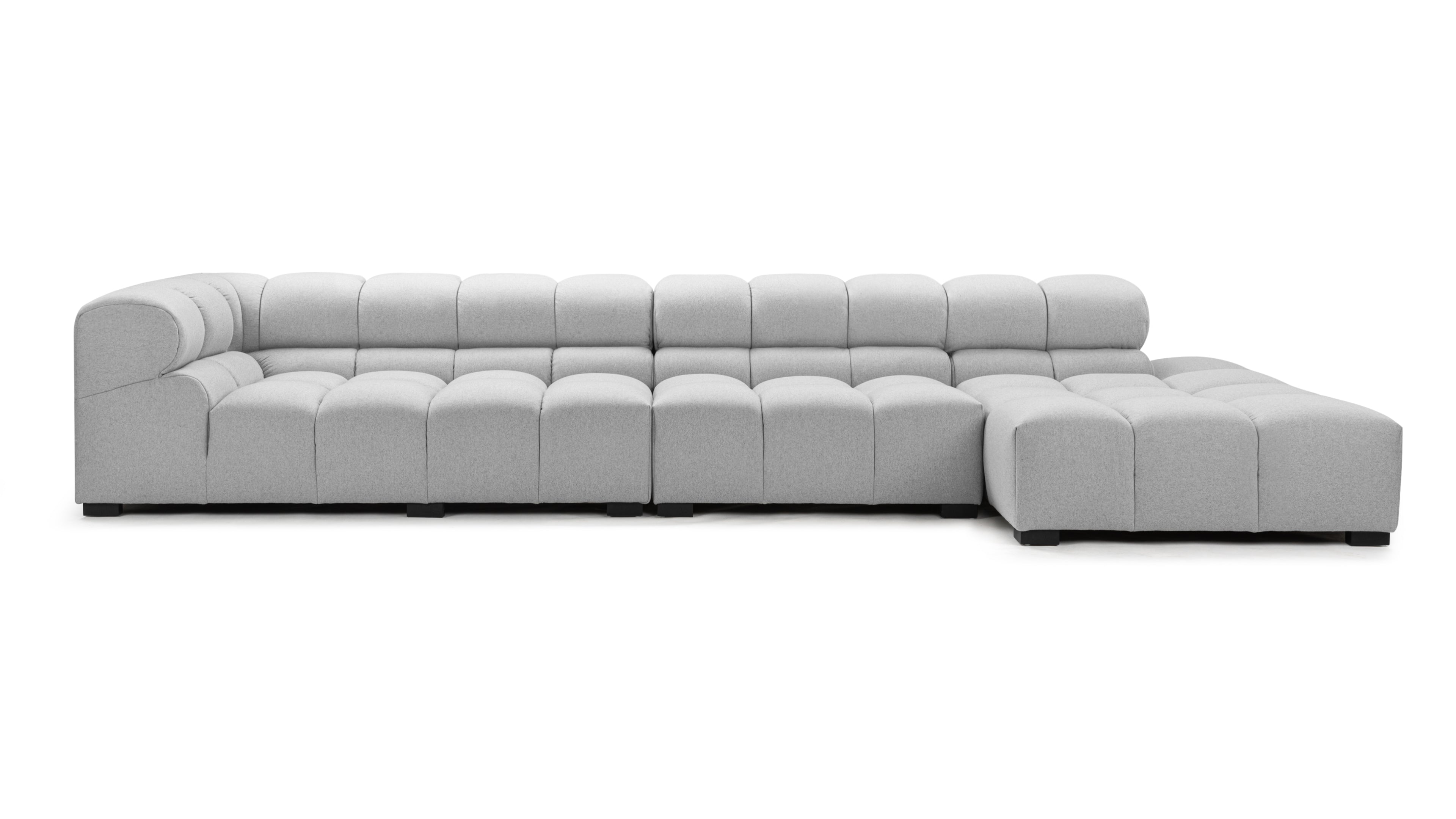 Elegant light gray wool tufted sectional sofa with right chaise in a modern living room setting, showcasing luxurious multi-layer foam cushions.