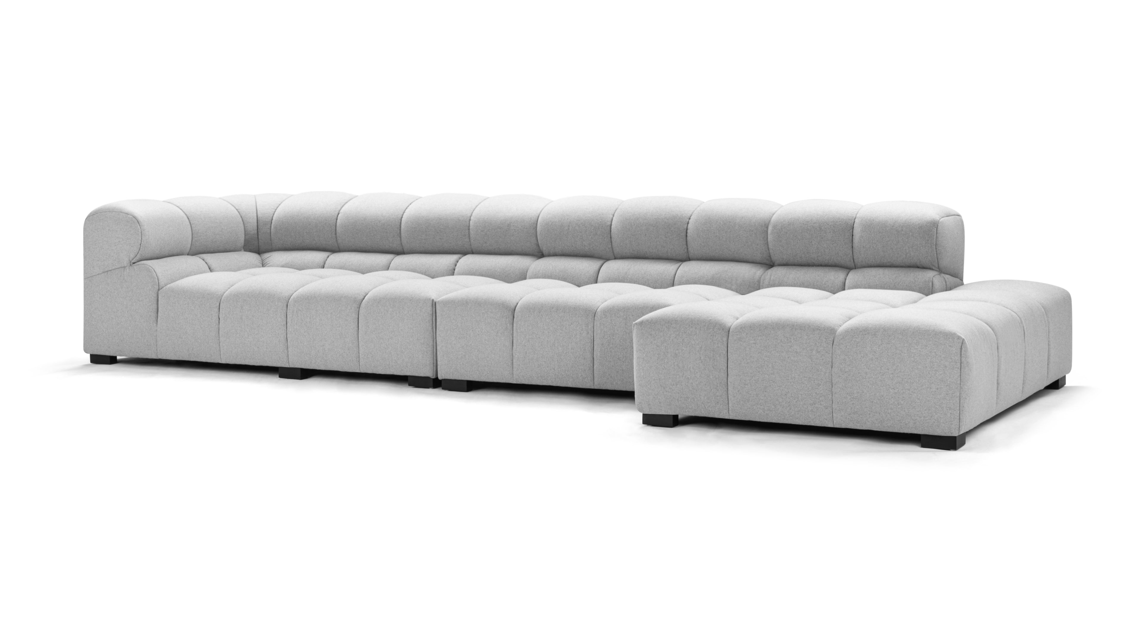 Contemporary light gray tufted couch with clean lines and a modular design, perfect for flexible living spaces and stylish interiors.