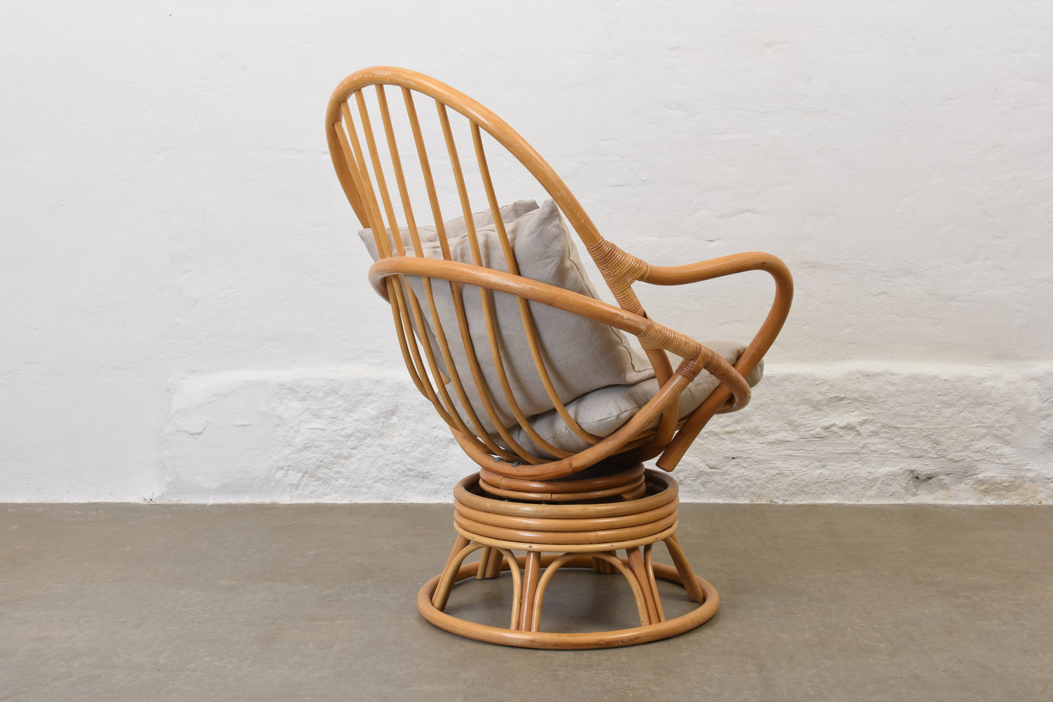 bohemian-rattan-swivel-chair-with-linen-cushions
