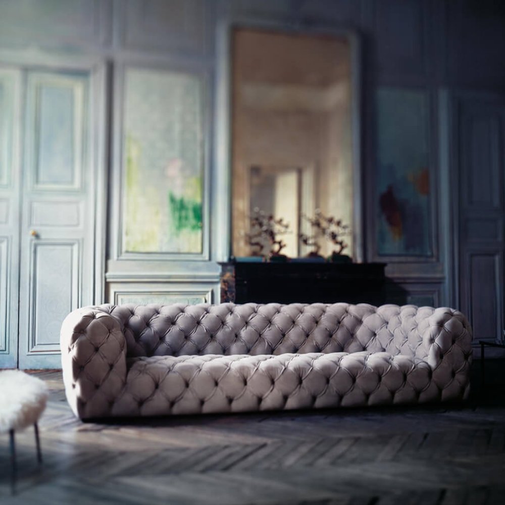 Durable modern Chesterfield sofa in a plush leather finish, perfect for upscale living spaces.