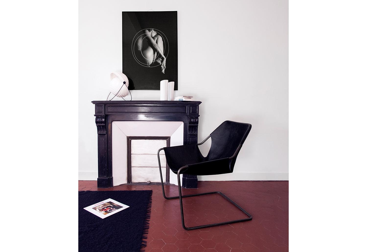 Sleek Paulistano armchair, ideal for reading or relaxing in a modern living space.